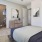 a bedroom with a window and a closet