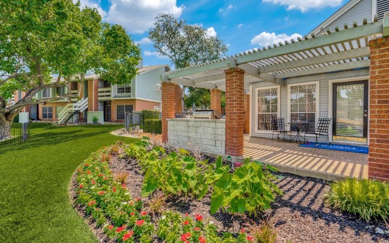 a building with a back yard with a flower bed