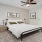 a bedroom with a bed and a fan