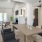 a dining room with a table and chairs leading into a living room